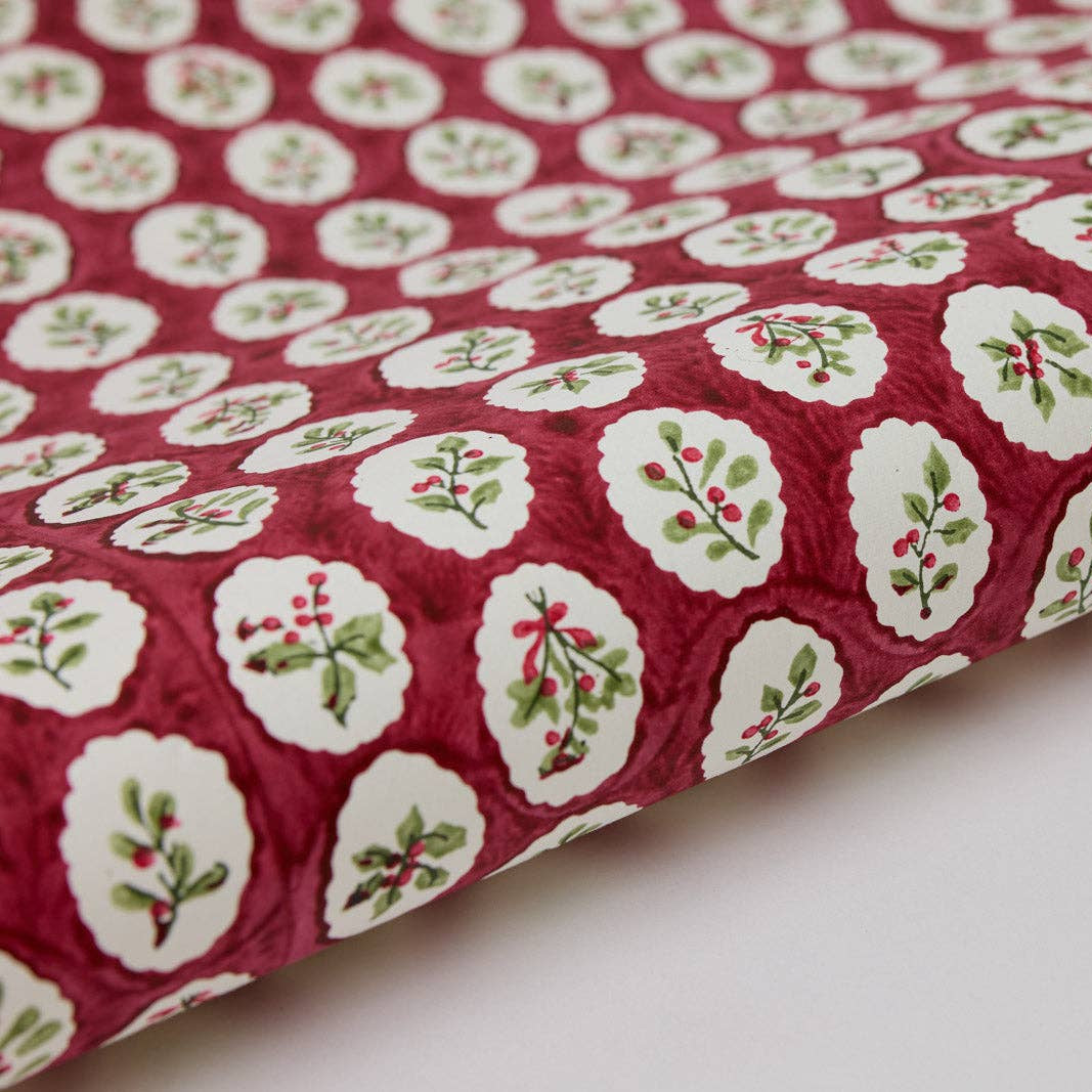 Red fabric with white floral patterns on a white background