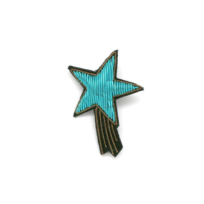 Star-shaped brooch with turquoise center and black edges on a white background, featuring mooncc and HABANA logos.